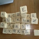 Stosy drewnianych płytek z literami do gry w Scrabble